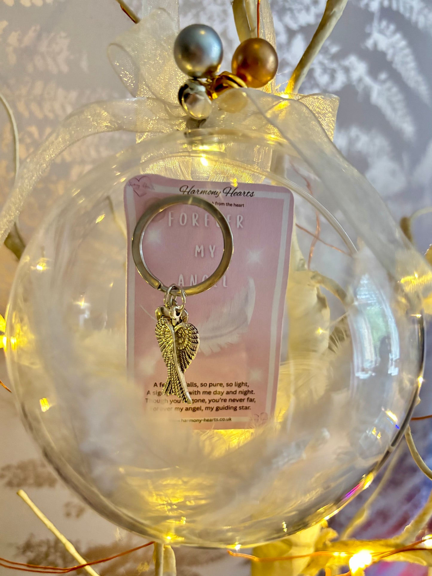 Clear Christmas bauble with an angel wings keepsake keyring inside