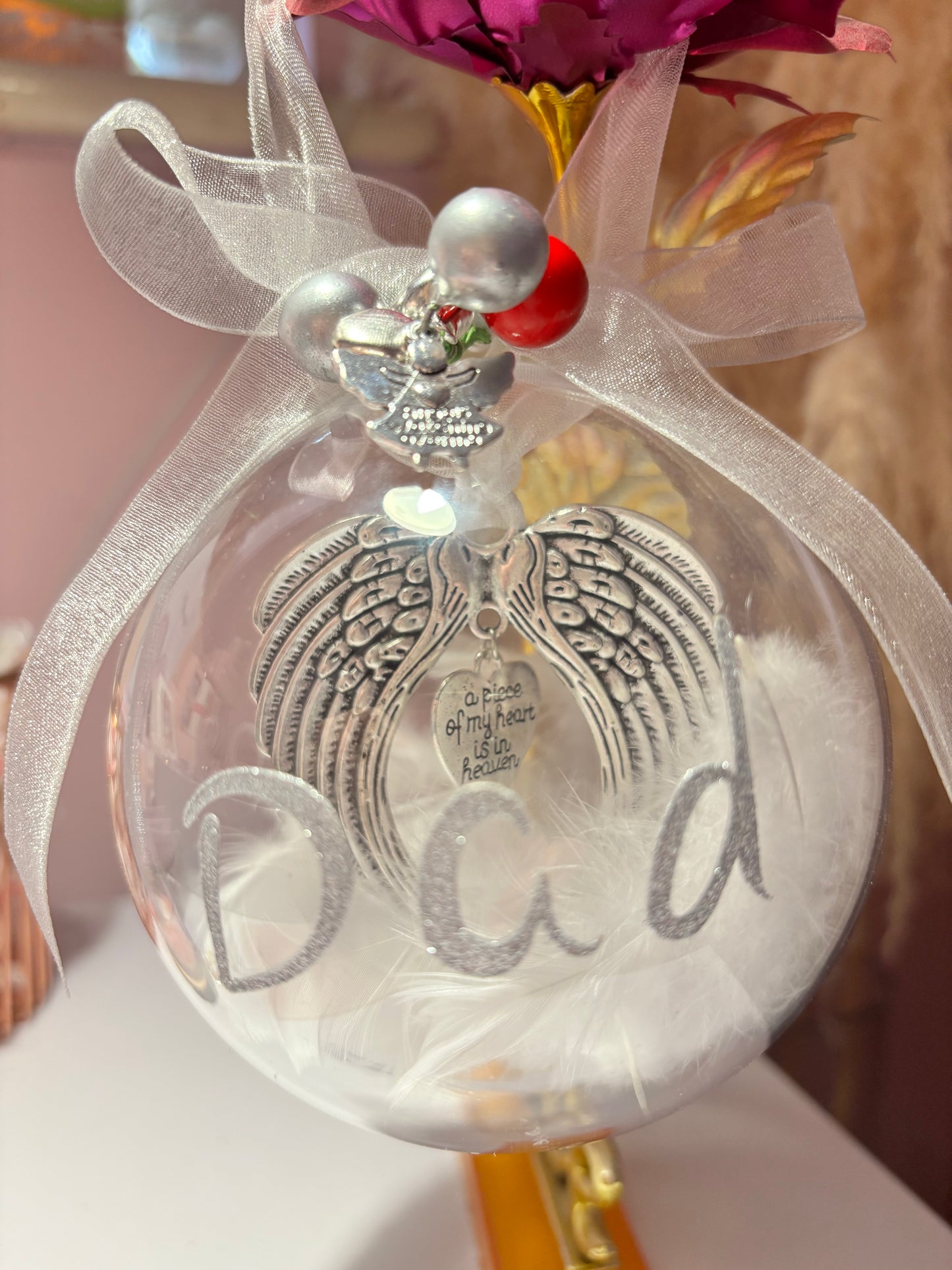Clear Christmas bauble with an angel wings keepsake inside and the word Dad in glitter letters