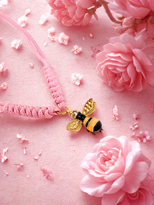 Pink bracelet with a bee charm on a pink floral background