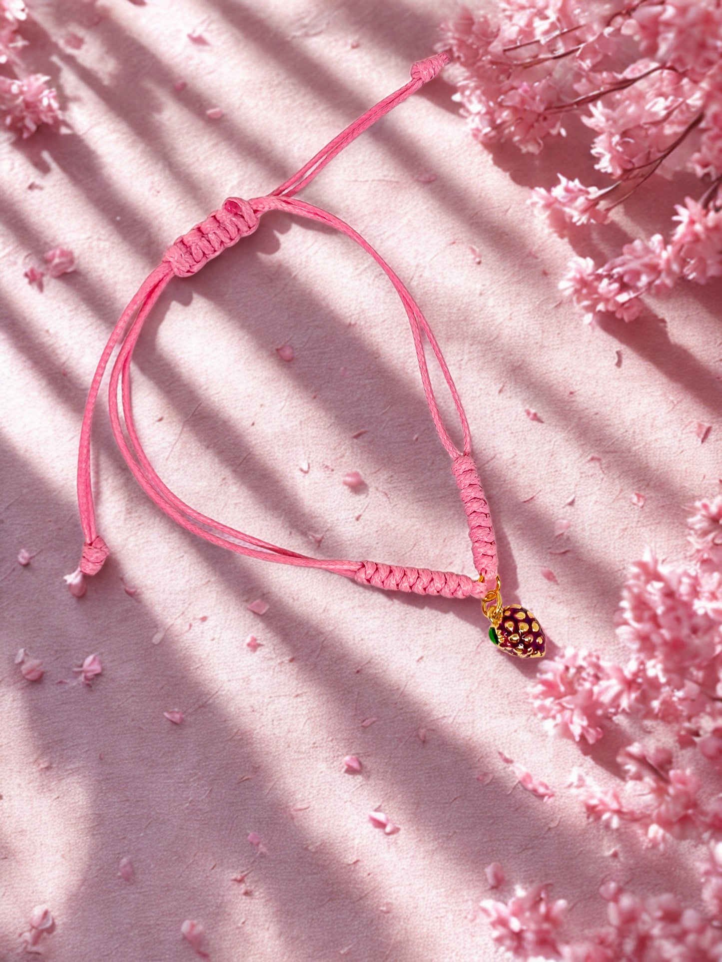 Pink cord bracelet with a blackberry charm