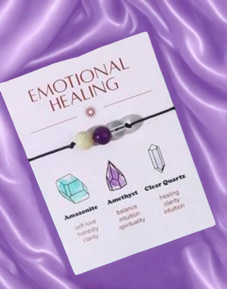 Emotional Healing bracelet packaging with crystals on a purple fabric background