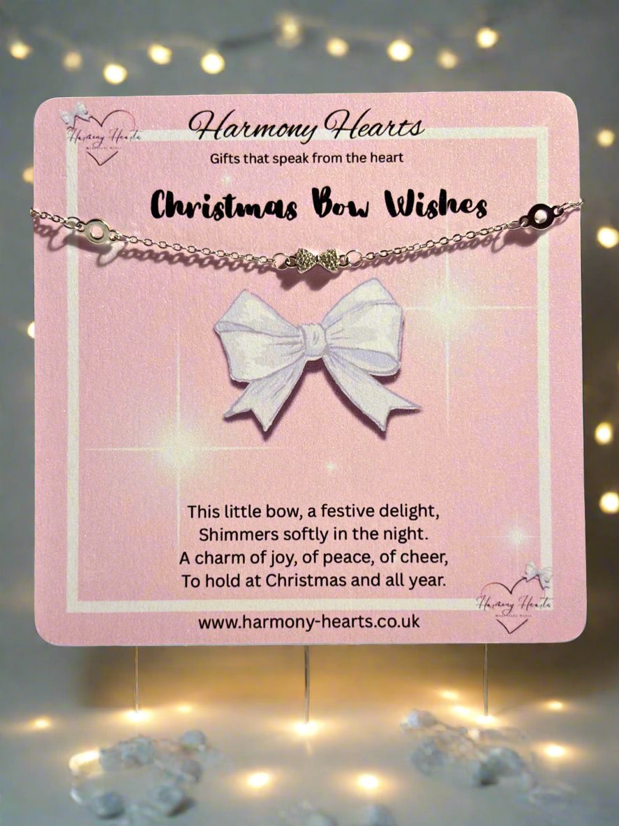 Bracelet with a bow pendant on a pink card with text, surrounded by decorative lights.