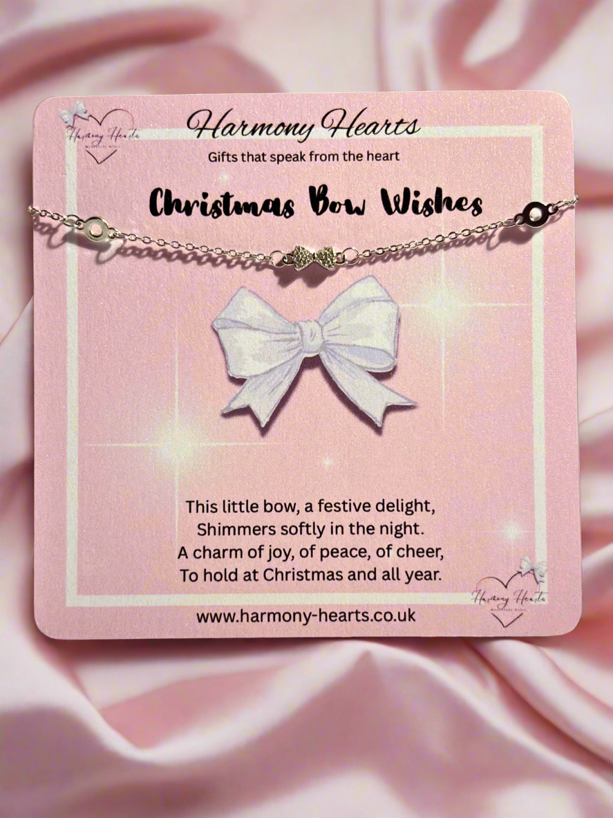 Bracelet with a bow pendant on a pink card with text, featuring 'Harmony Hearts' branding.
