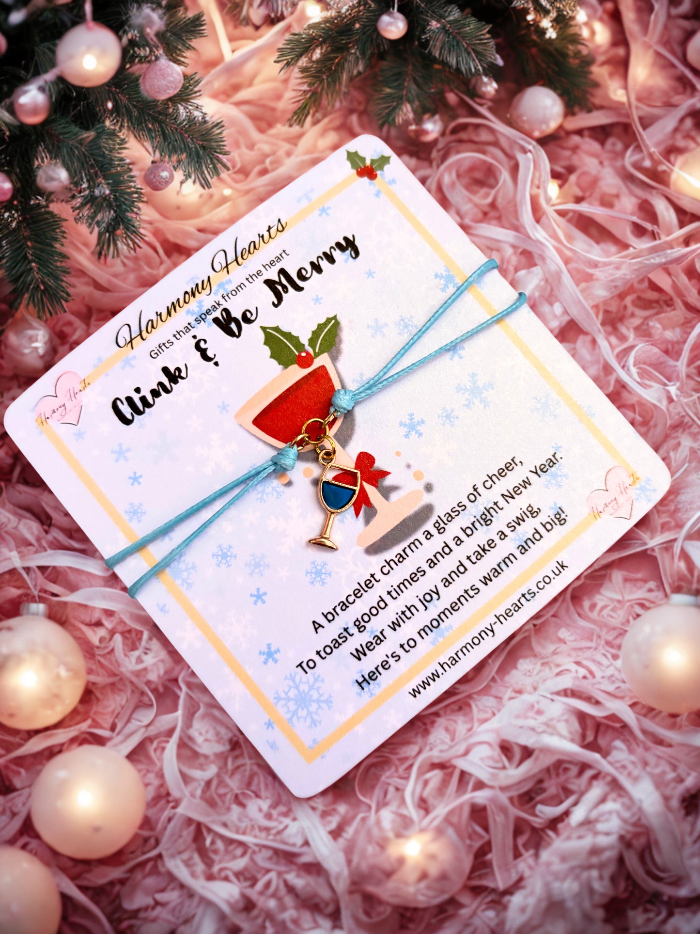 Bracelet with Christmas-themed wine glass charm on a decorative card with festive background