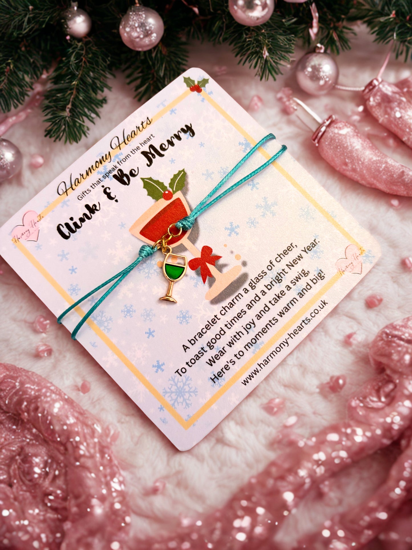Bracelet with wine glass charm on a festive card on a decorative background