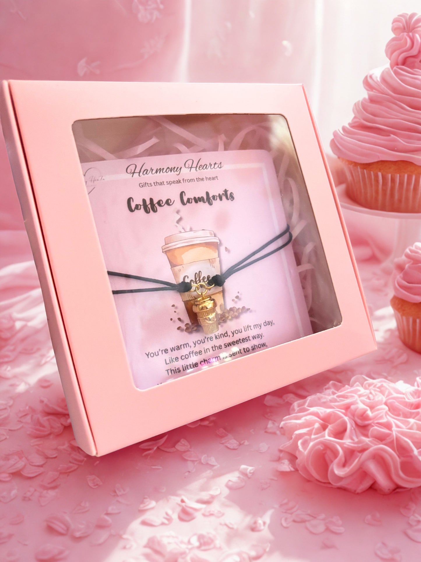 Pink gift box with 'Harmony Hearts' coffee cup charm bracelet product on a pink floral background