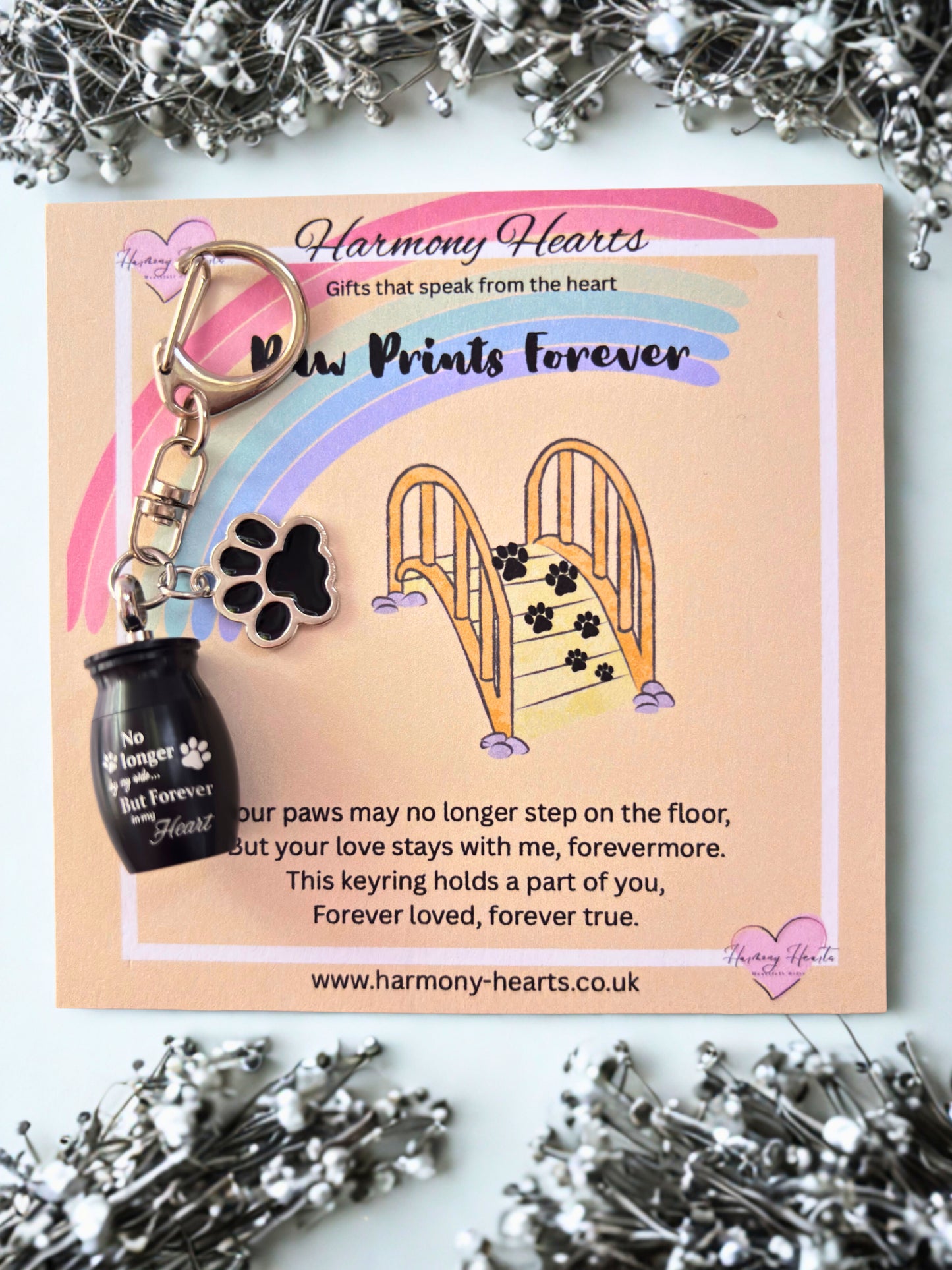 Keychain and card set with rainbow design and 'Harmony Hearts' branding.
