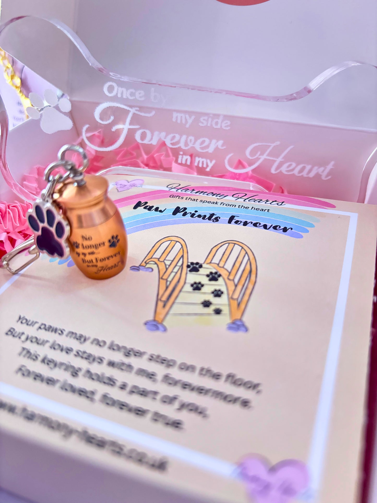 Keychain with paw prints and heart design on a card with text