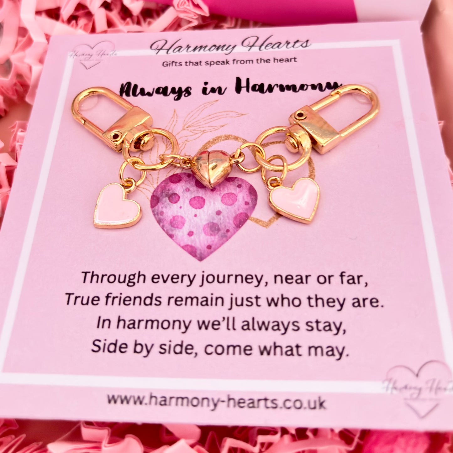 Gold keychain with heart charm on a pink card from Harmony Hearts