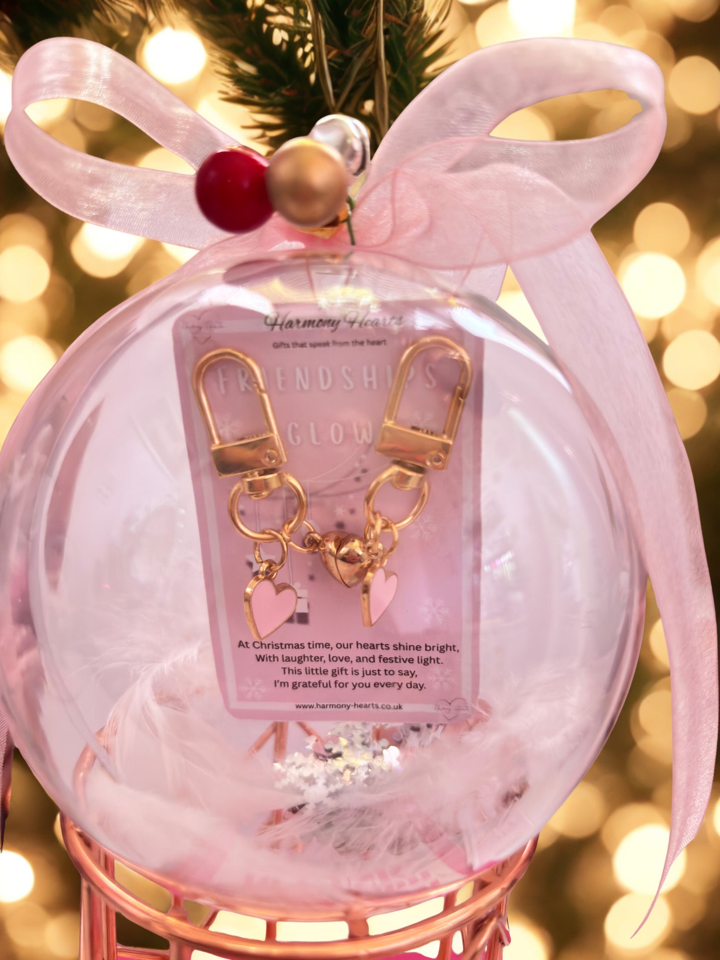 Decorative ornament with pink bow and keychain on a blurred festive background
