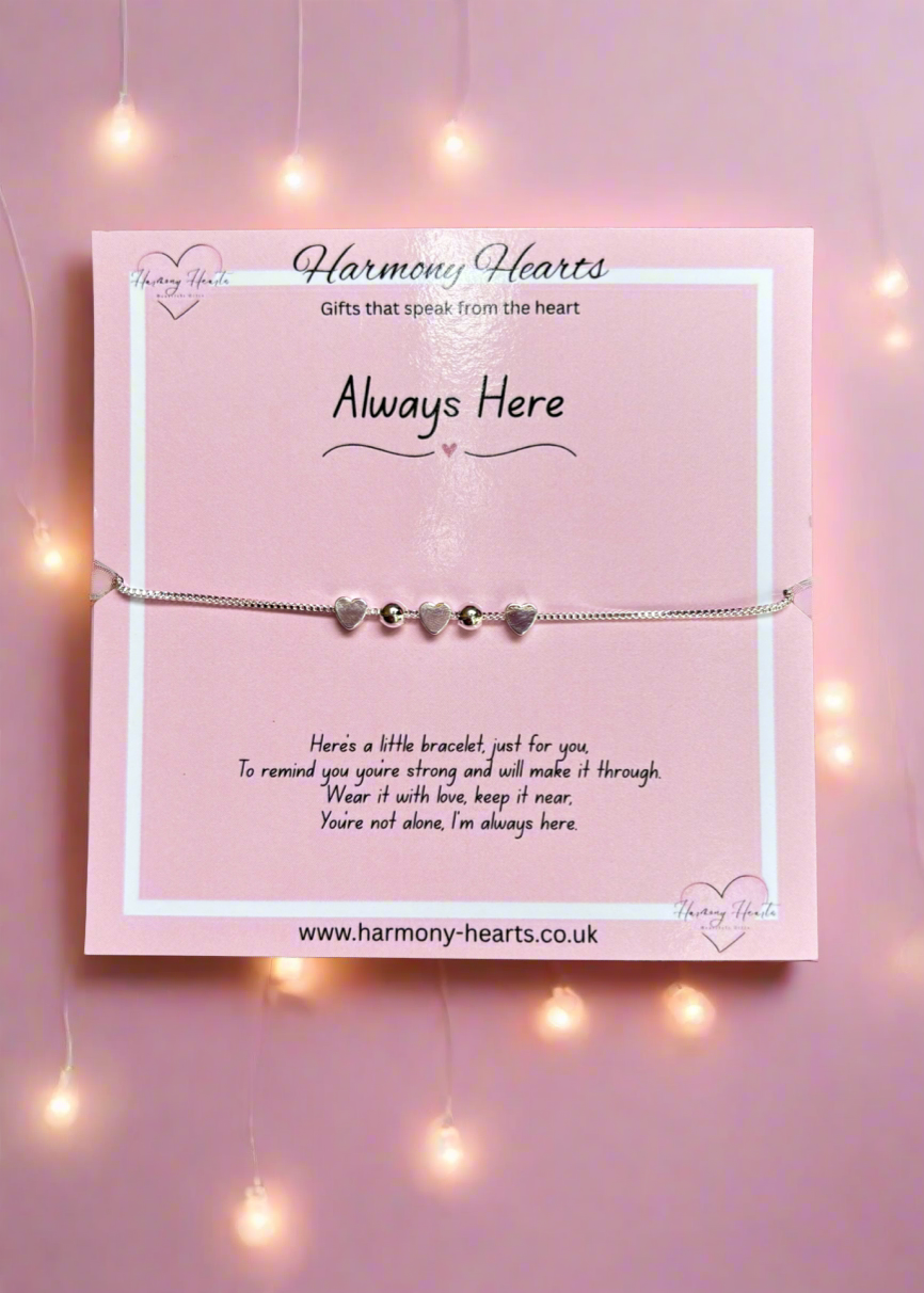 Bracelet on a card with 'Harmony Hearts' branding against a pink background with string lights.