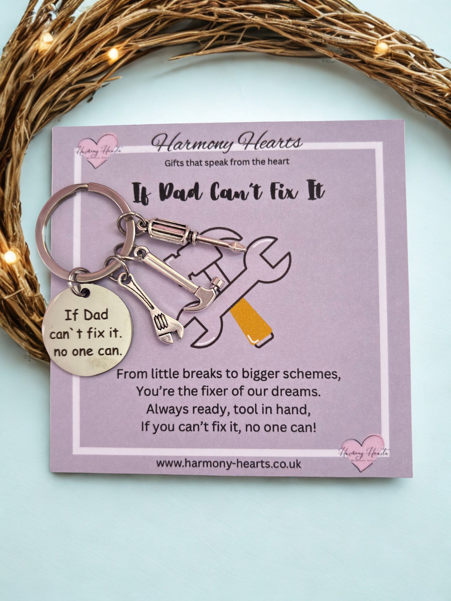 Keychain with heart-shaped tag on a 'Harmony Hearts' card with text.