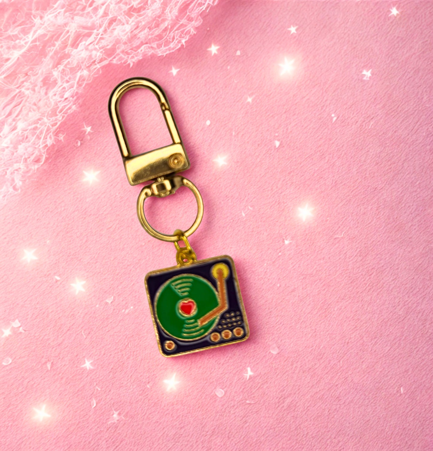Keychain with record player design on a pink background