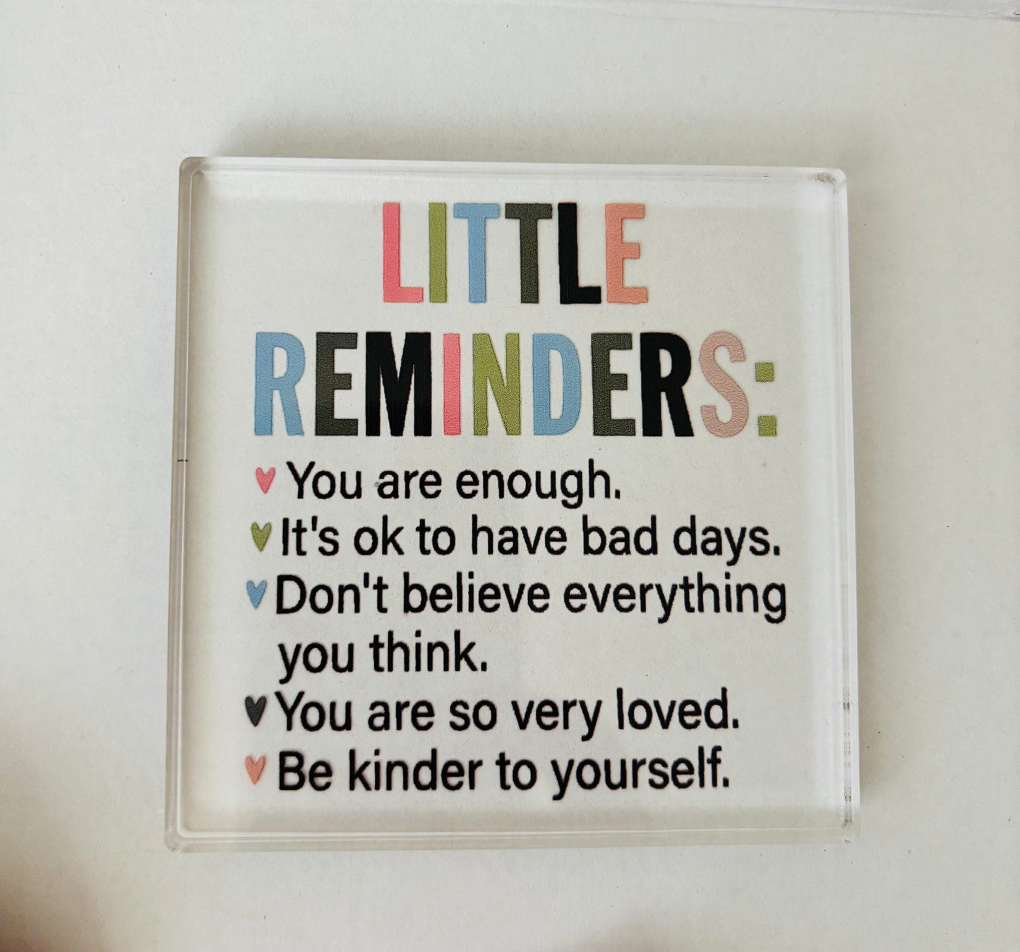 Decorative sign with motivational phrases on a white background