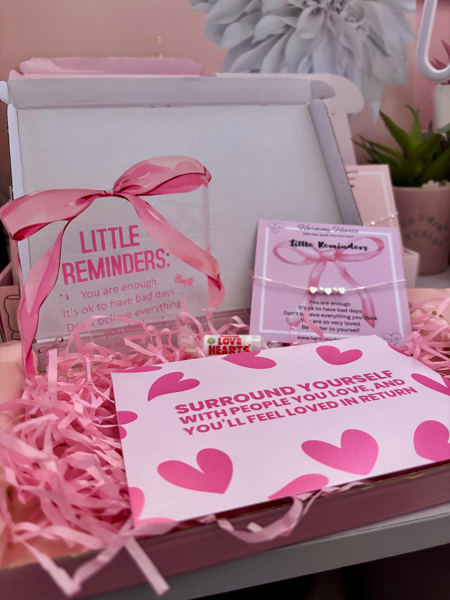 Pink-themed gift set with 'Little Reminders' product and motivational card.
