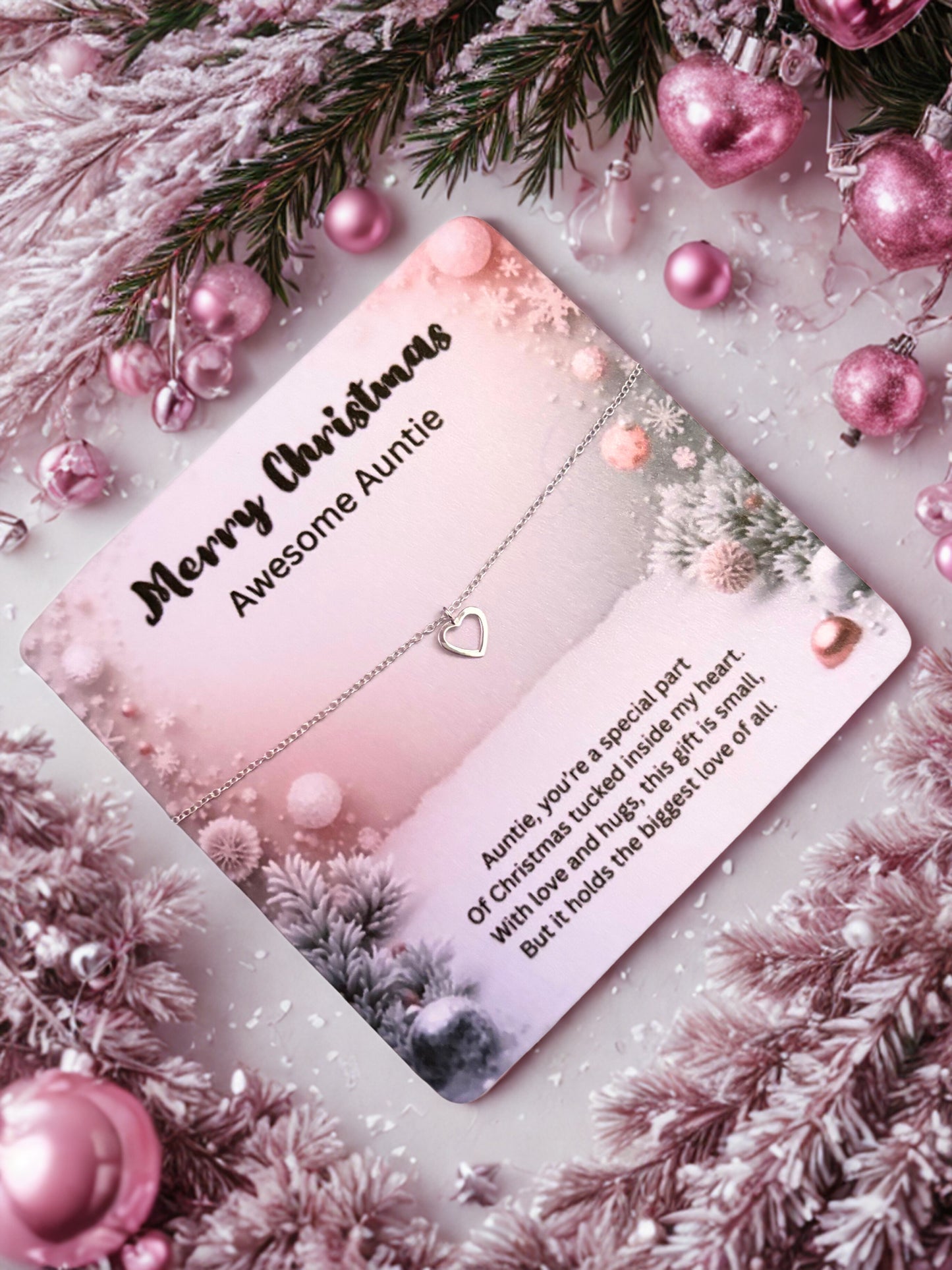 Silver heart bracelet on a Greeting card with 'Merry Christmas Awesome Auntie' message surrounded by festive decorations.