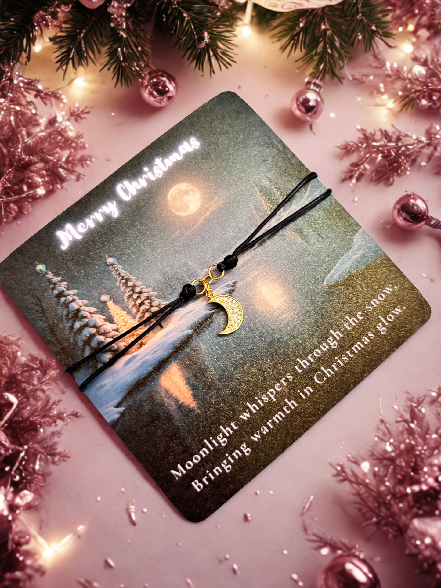 Card with Christmas scene and gold moon charm bracelet on a festive background
