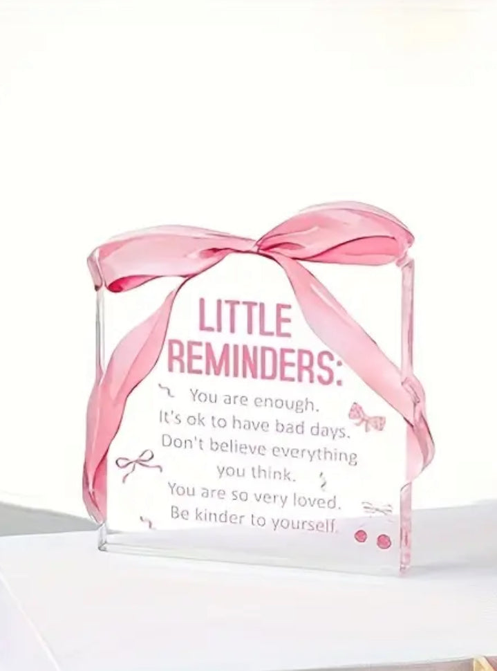 Acrylic block with pink ribbon and motivational text on a white background