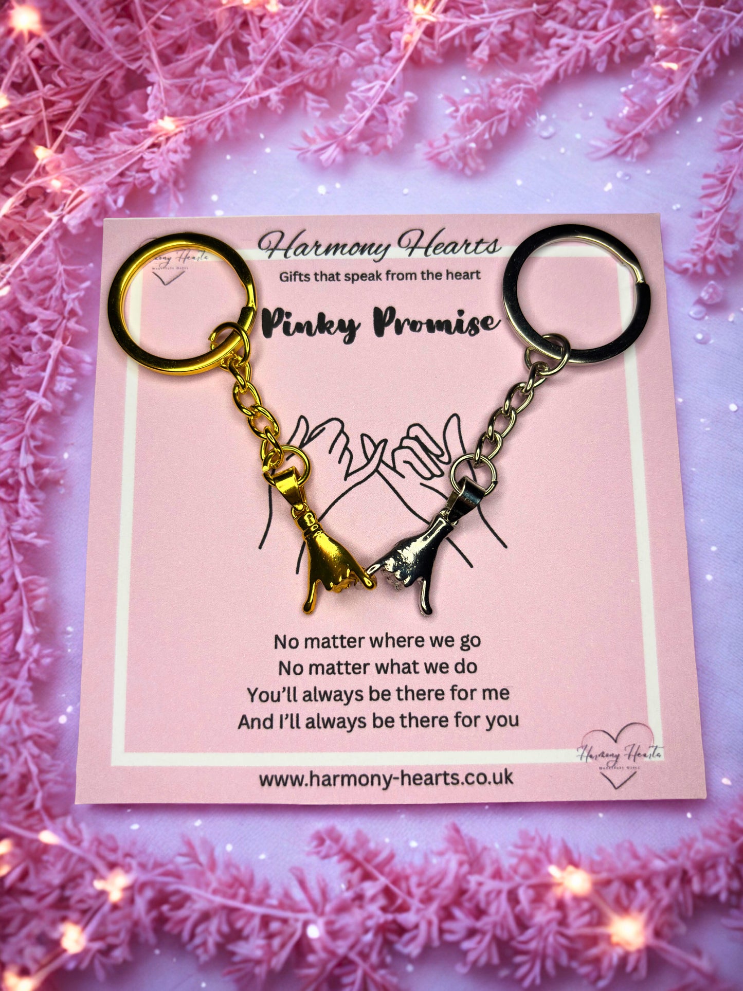 Keychain with heart design on a pink card with decorative pink background