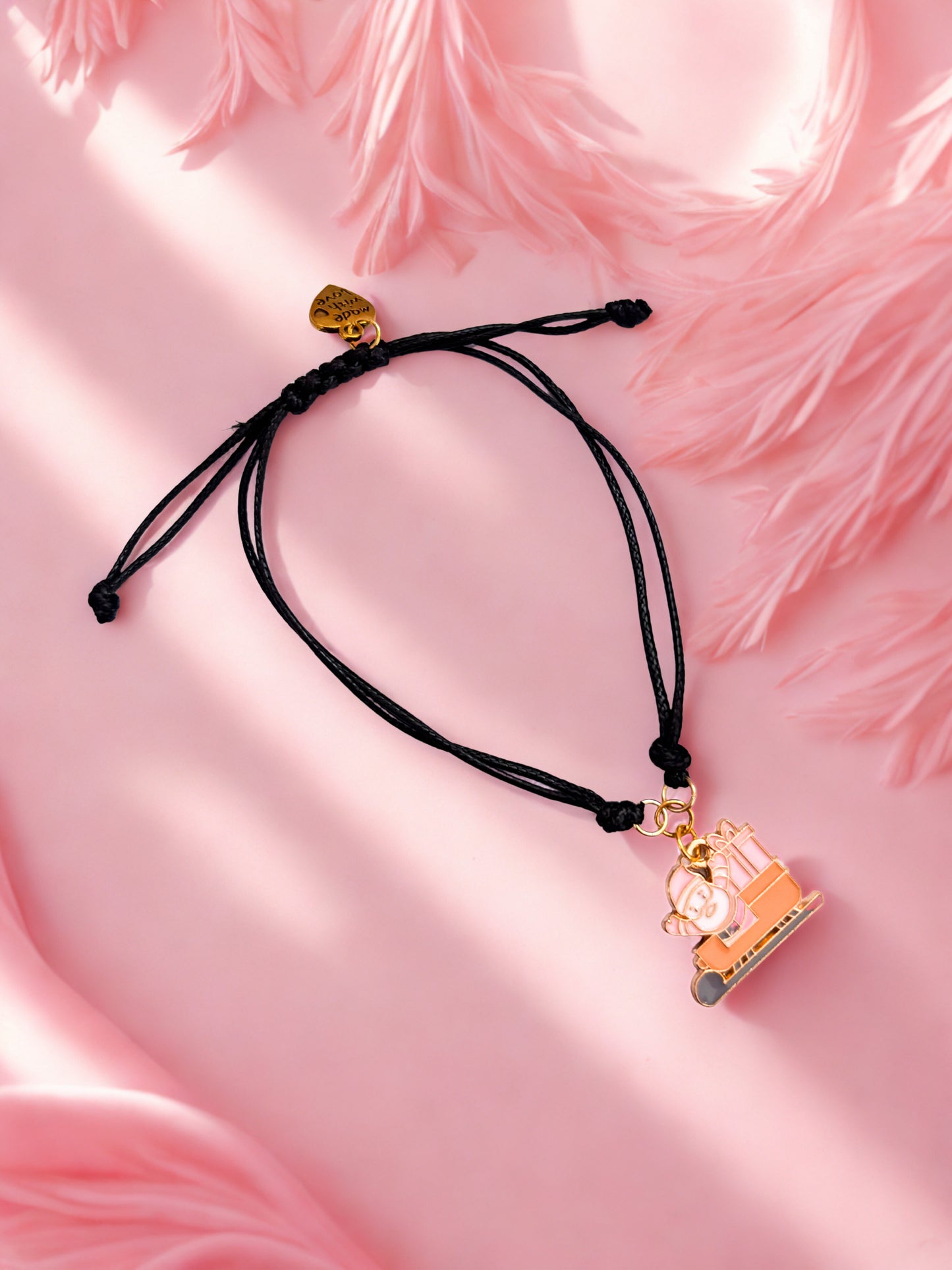 Black cord charm bracelet with a pink santa and sleigh