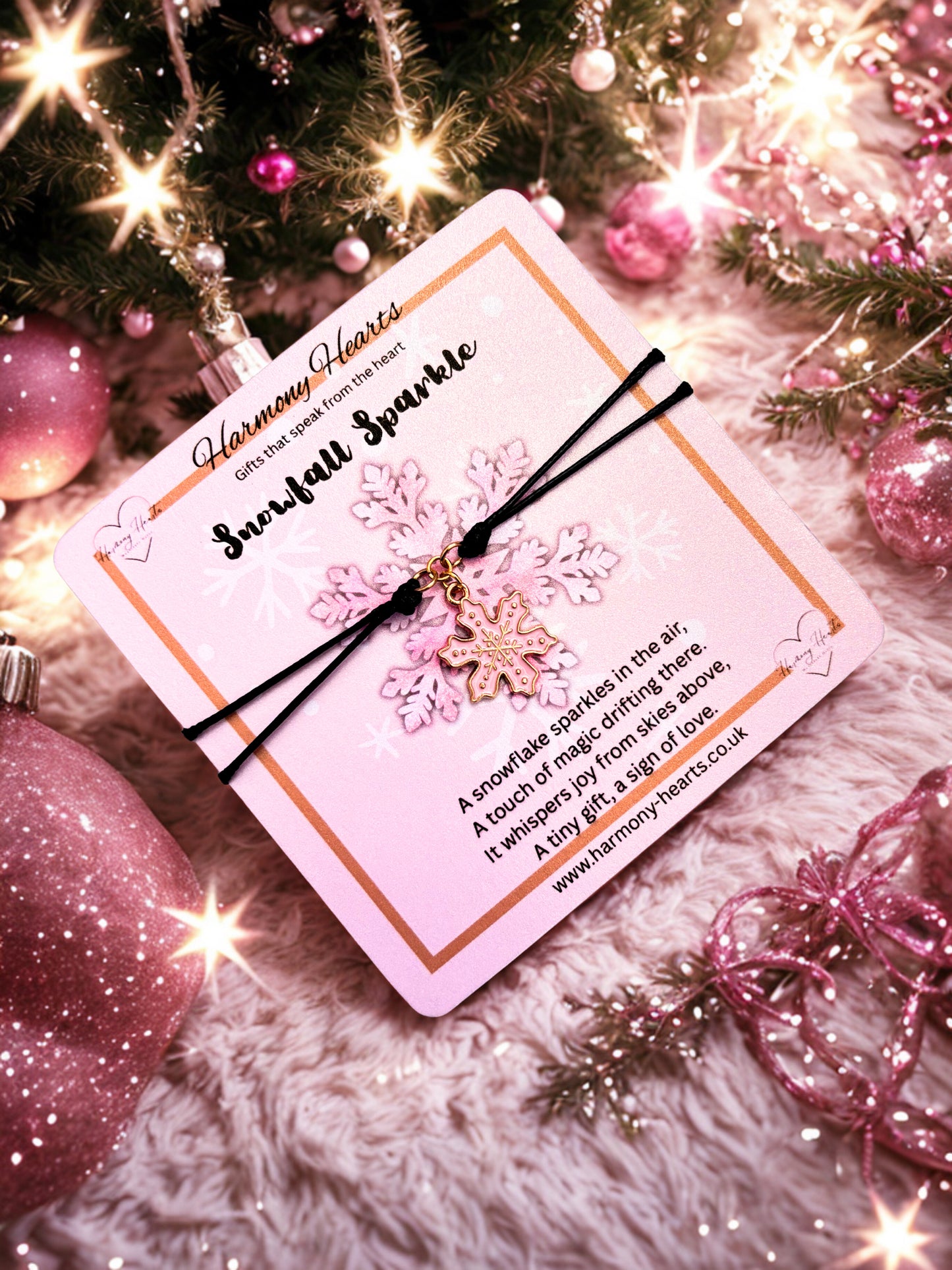 Snowflake charm bracelet with card on a festive background