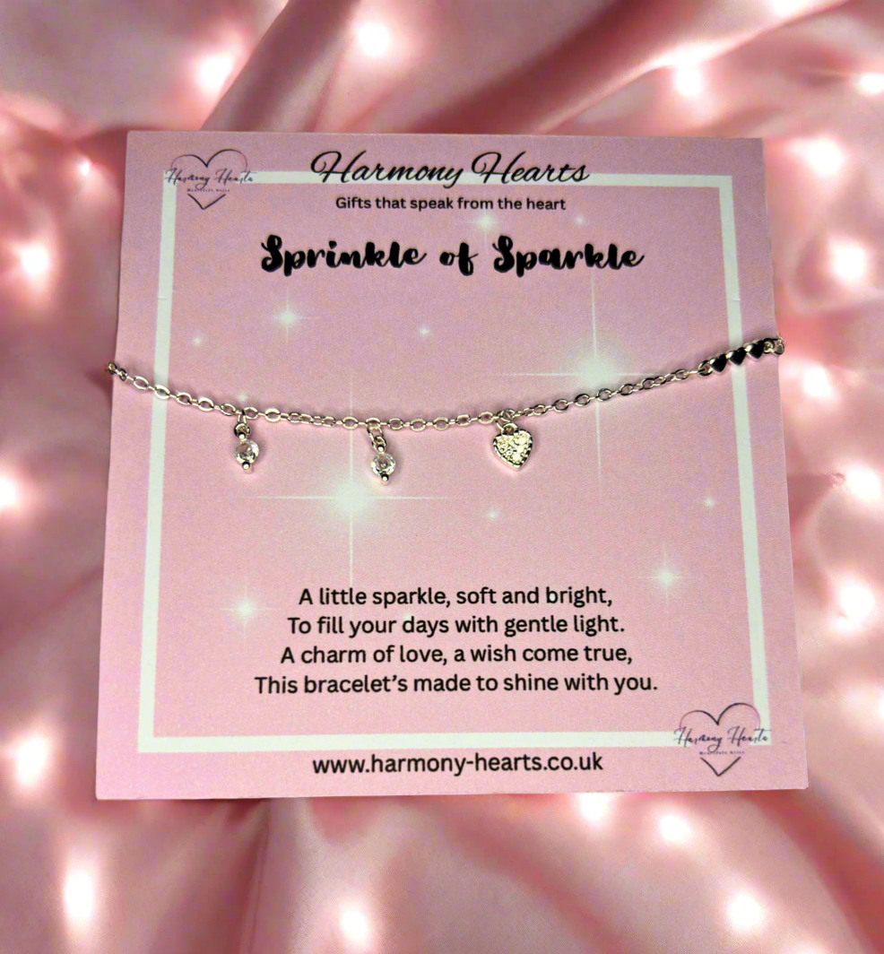 Bracelet with heart charm on a pink card with 'Harmony Hearts' branding