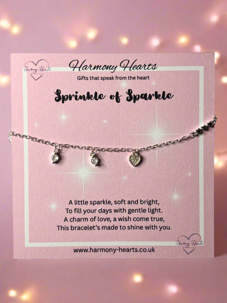 Bracelet with heart-shaped charms on a pink card with 'Harmony Hearts' branding.