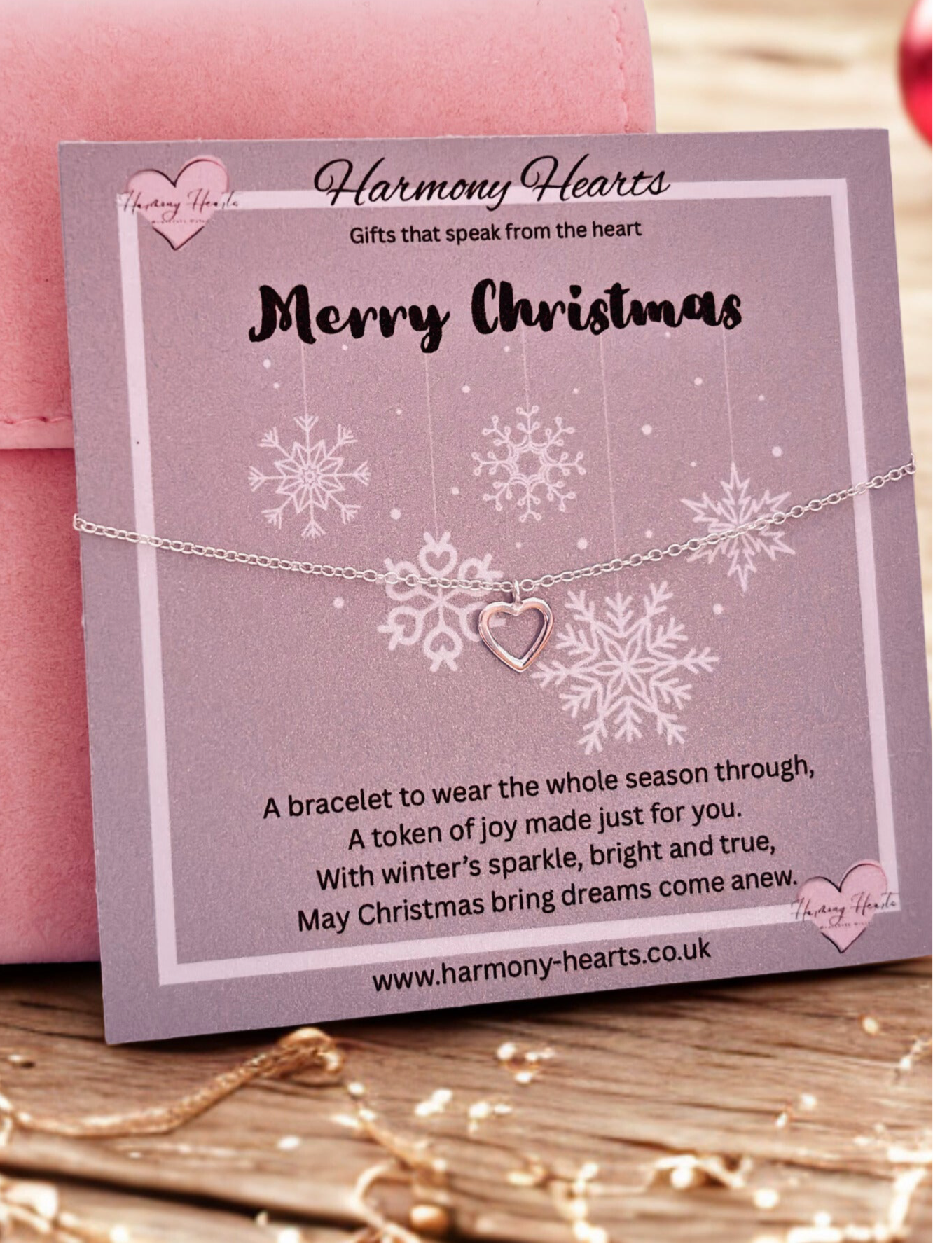 Bracelet with heart charm on a 'Harmony Hearts' branded card with Christmas message.