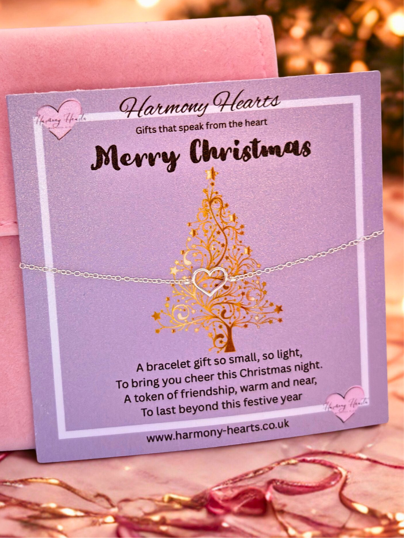 Silver bracelet on a purple card with 'Harmony Hearts' branding and Christmas tree design.