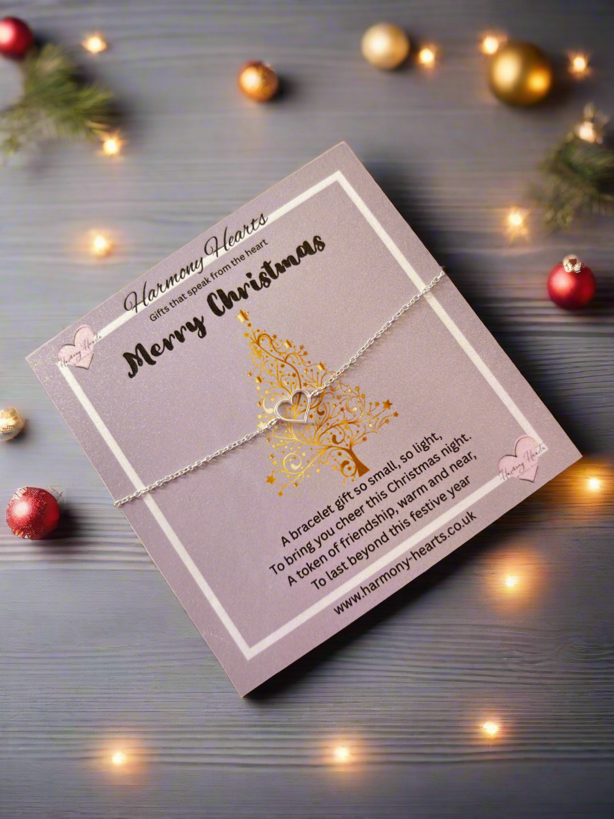 Silver bracelet on a Christmas-themed card with decorative lights and ornaments.