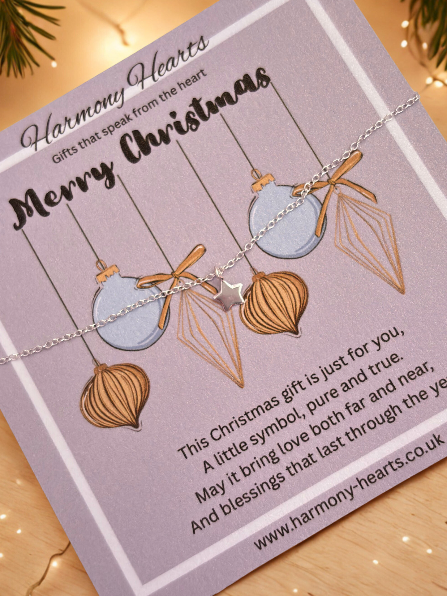 Bracelet with heart and geometric pendant on a 'Harmony Hearts' card with Christmas message.