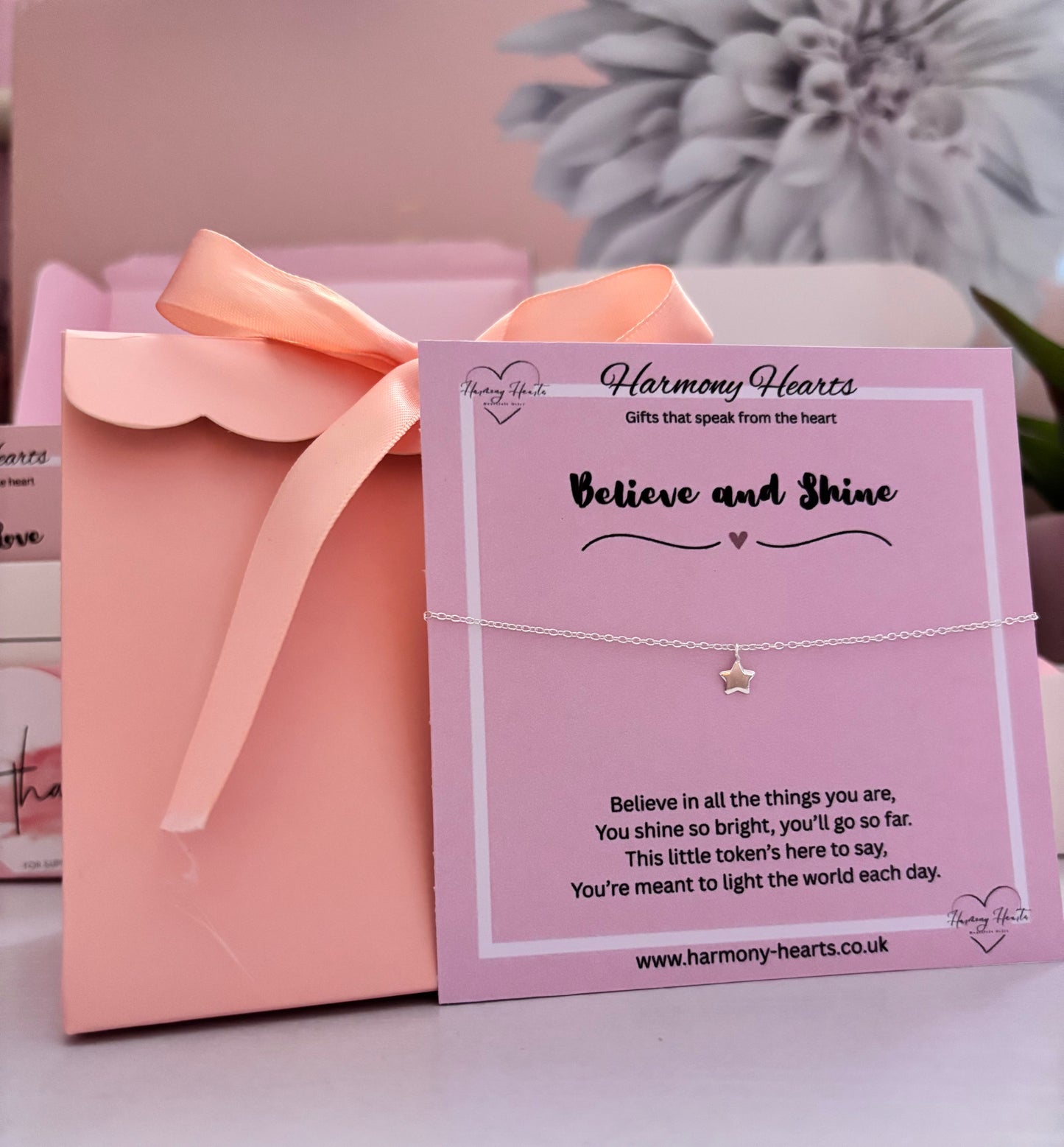 Star bracelet on a pink card with 'Harmony Hearts' branding, placed on a pink box.