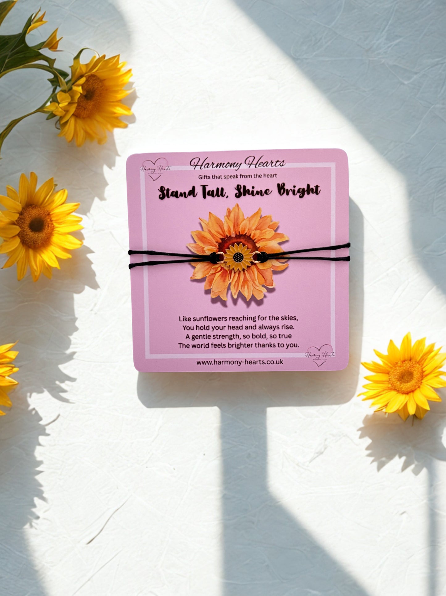 Sunflower-themed product packaging with sunflowers around on a light background