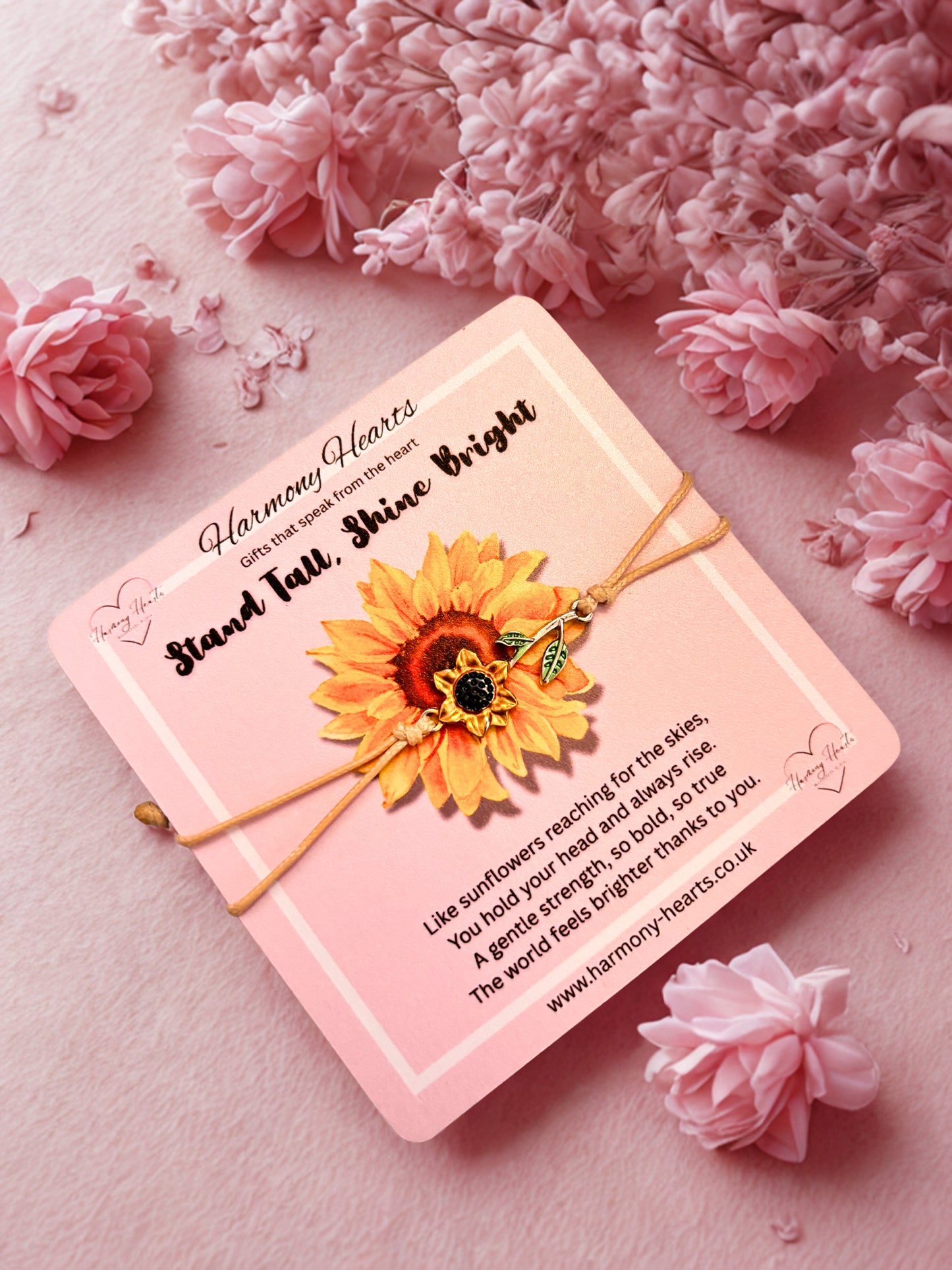 Pink card with sunflower design and text on a pink floral background