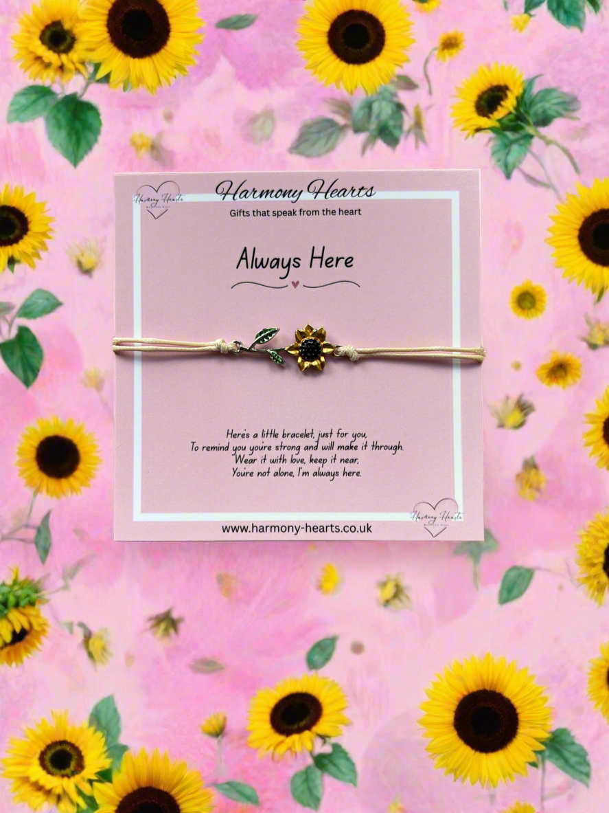 Bracelet with a message card on a pink background with sunflower pattern, featuring 'Harmony Hearts' brand.