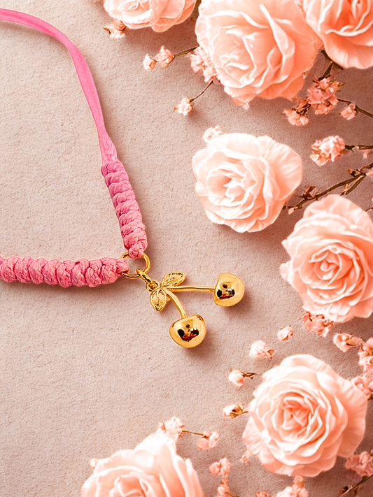 Pink cord bracelet with a gold cherry charm
