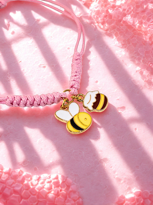 Pink cord bracelet with bee and honey pot charms