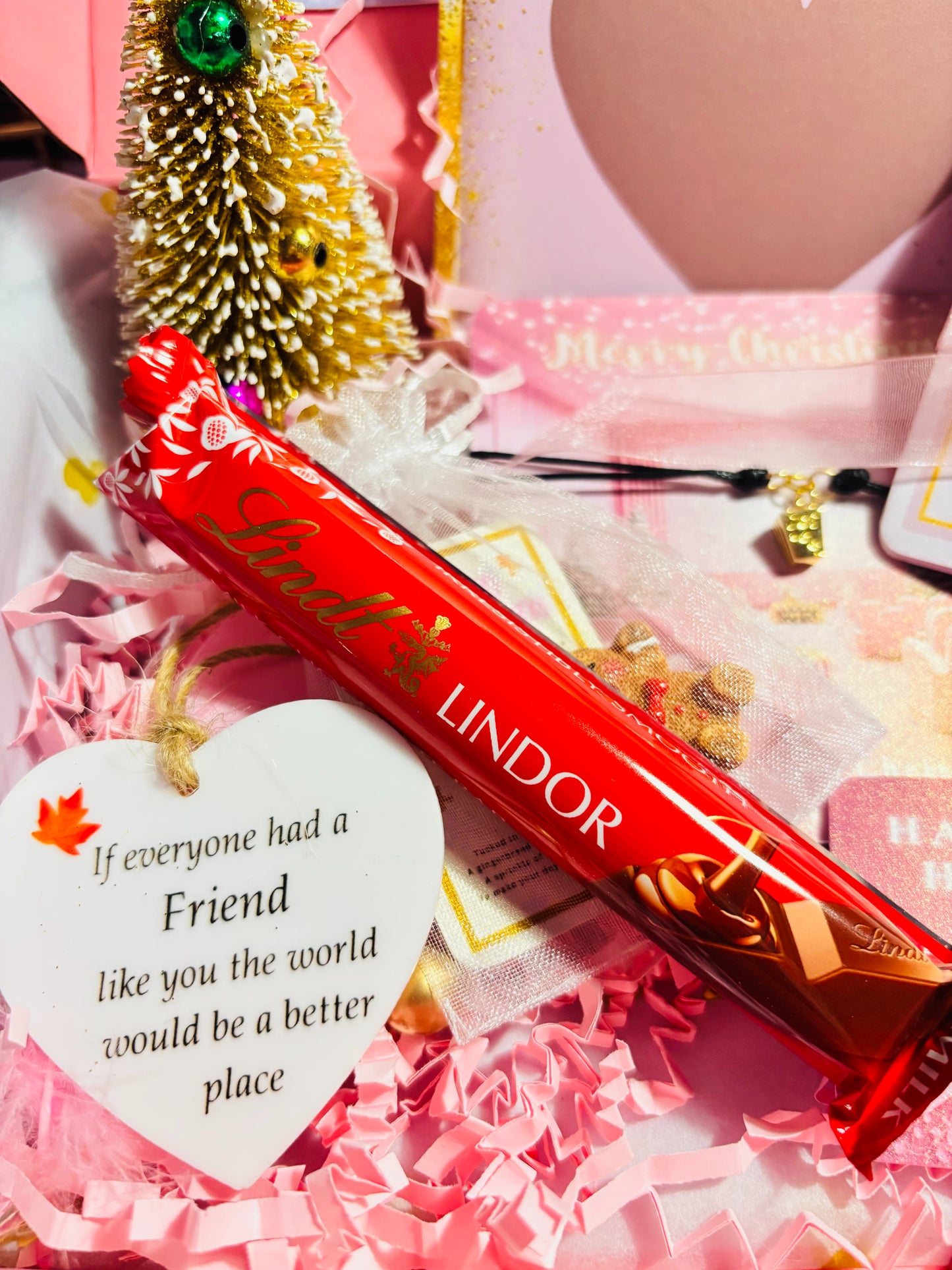 Lindor chocolate bar with festive packaging on a pink background