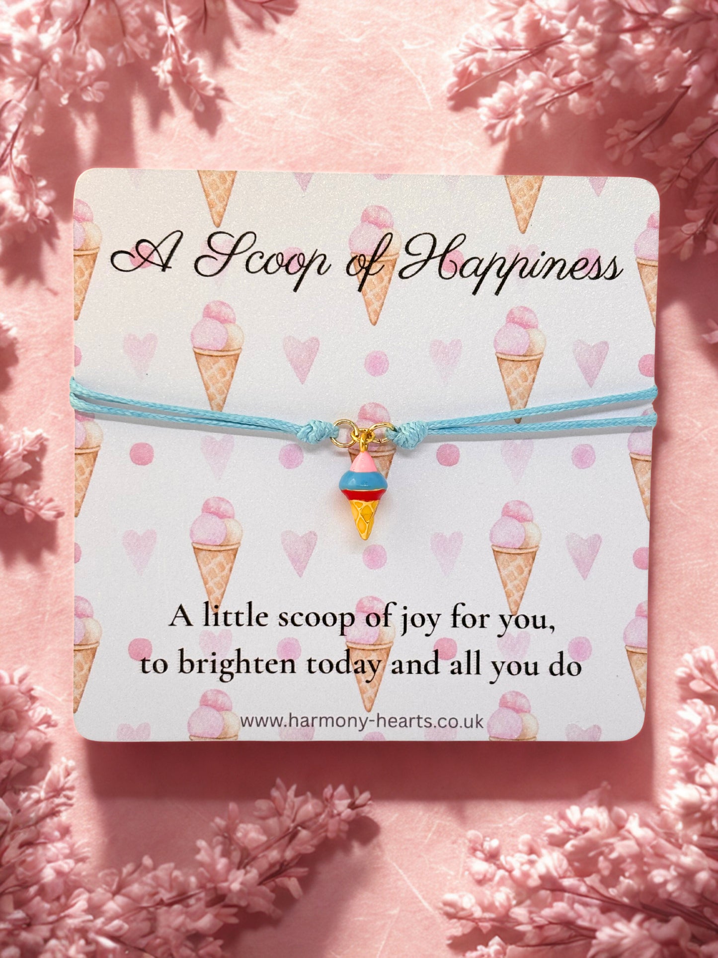 Branded Harmony Hearts card with ice cream cone design and an ice cream charm bracelet on a blue cord
