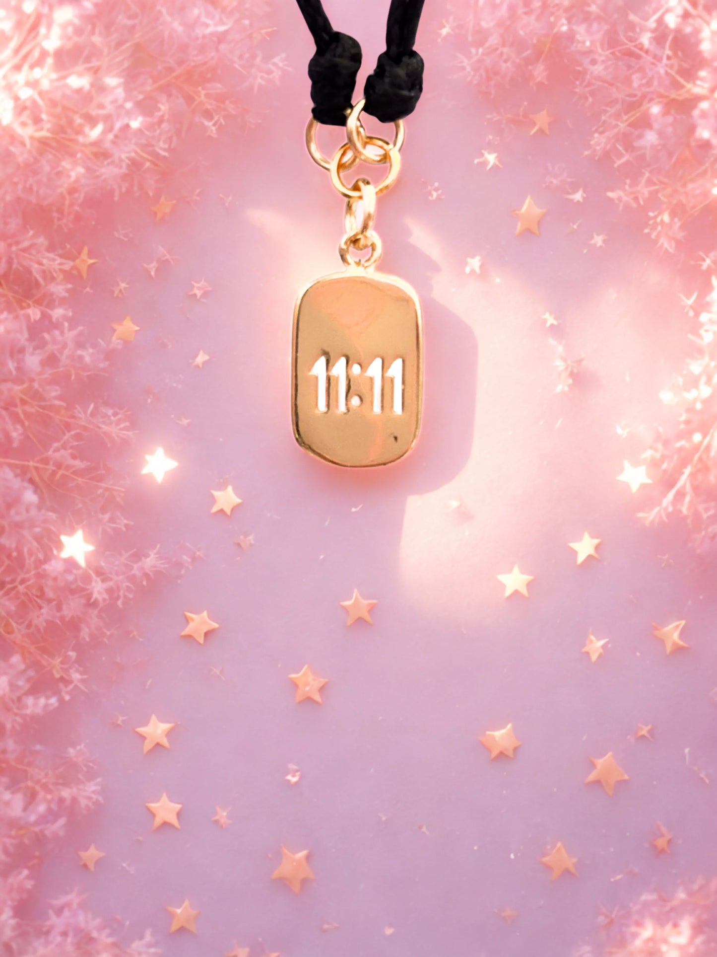 Gold 1111 charm on a black cord bracelet