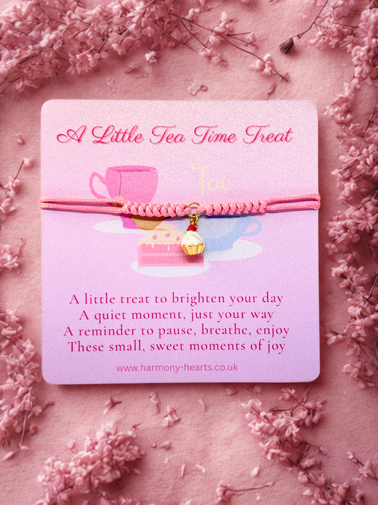 Pink cord bracelet with cupcake charm presented on a Harmony Hearts branded card