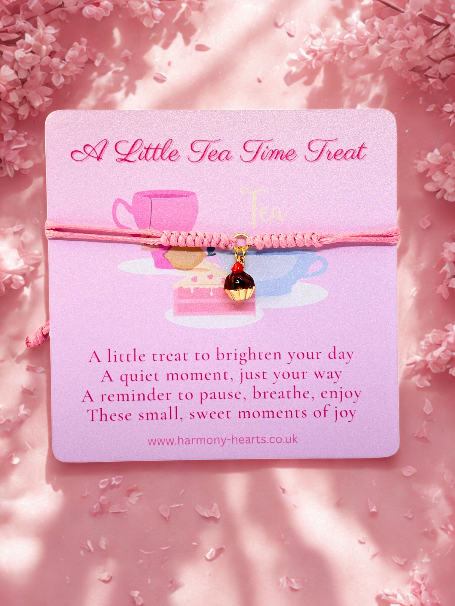 Pink cord bracelet with a upcake charm presented on a branded Harmony Hearts illustrated card