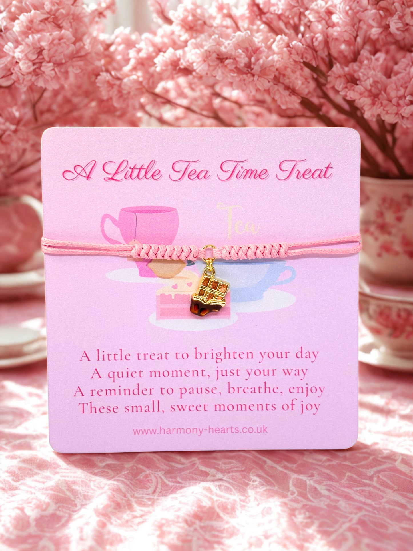 Pink cord bracelet with a bar of chocolate charm presented on a branded Harmony Hearts card