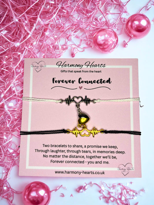 Two bracelets on a pink card with 'Harmony Hearts' branding, surrounded by pink beads and ribbons.