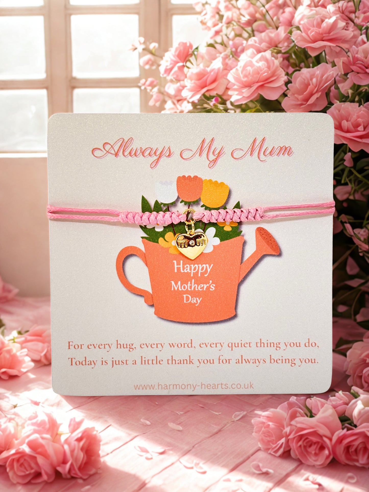 Harmony Hearts branded card with 'Always My Mum' and 'Happy Mother's Day' text, featuring a watering can design, surrounded by pink flowers. With a pink cord bracelet with gold heart charm