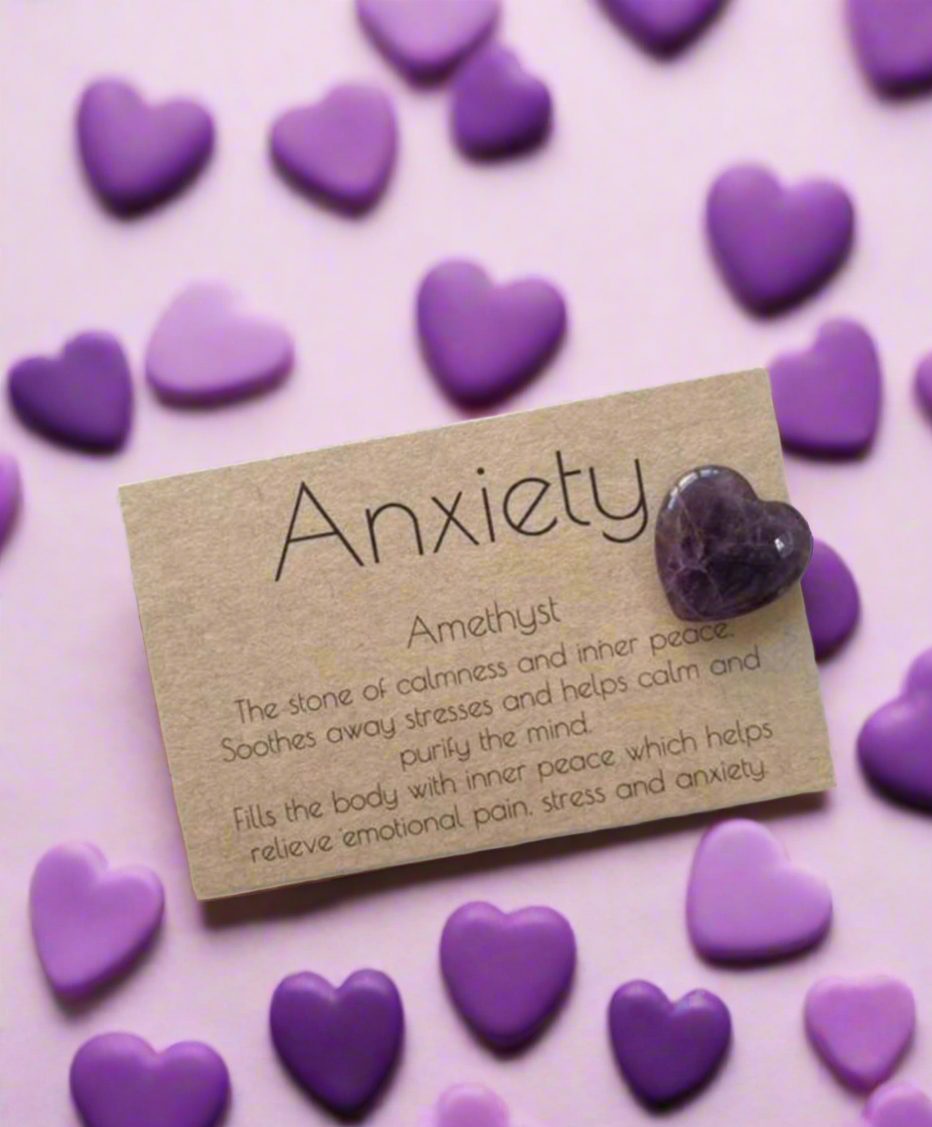heart placed on a natural kraft card with the word 'Anxiety' written above. The card is surrounded by purple heart-shaped confetti.