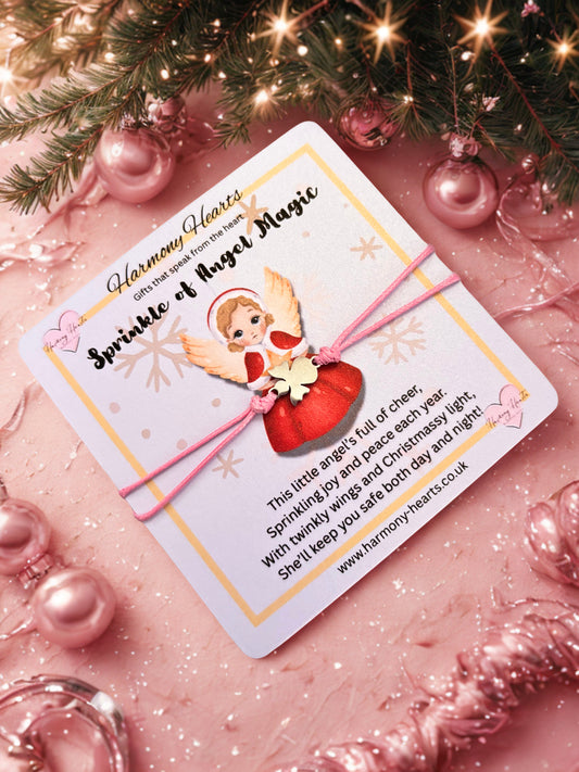 Bracelet on a card with angel illustration and text on a festive background with pink ornaments and lights.