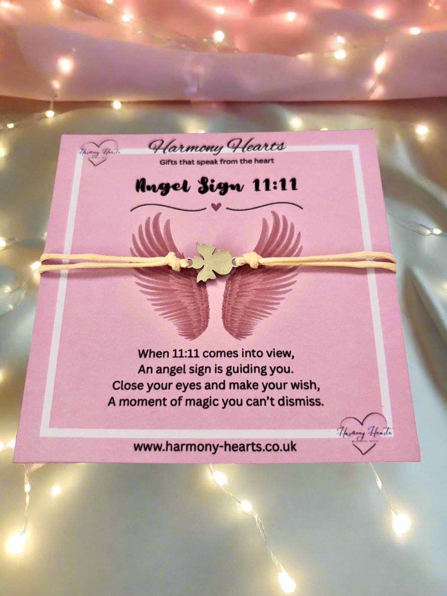 Pink card with angel wings and text on a soft pink background