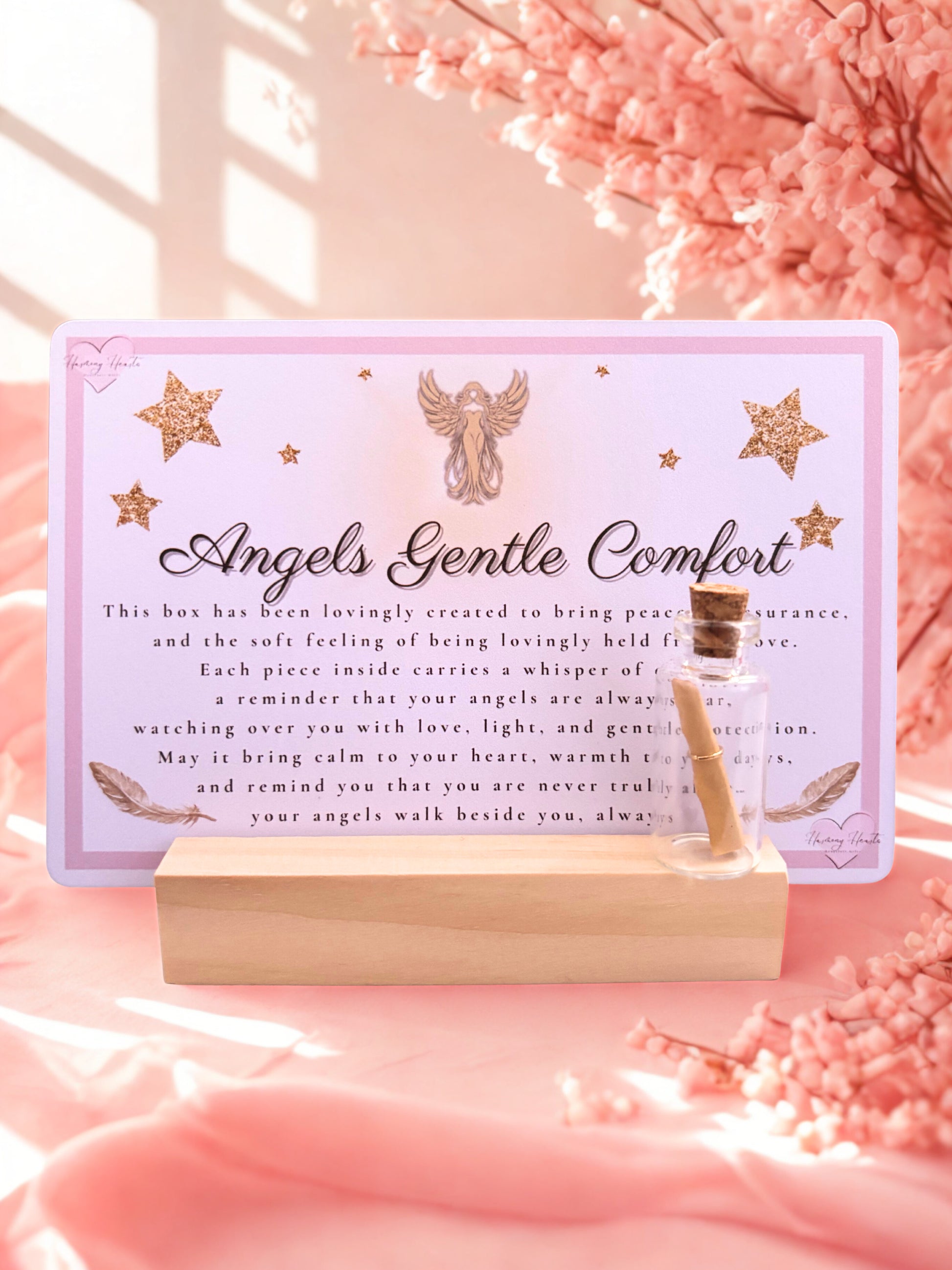Decorative card with angel design and text and a pink wish bottle on a pink background
