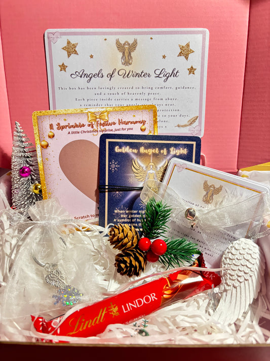 Decorative gift set with cards, ribbons, and festive elements on a pink box.